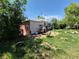 An overgrown backyard of a single Gathering house with assorted objects at 1266 Del Mar Pkwy, Aurora, CO 80010