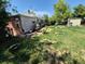 An overgrown backyard of a single Gathering house with assorted objects at 1266 Del Mar Pkwy, Aurora, CO 80010