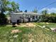An overgrown backyard of a single Gathering house with assorted objects at 1266 Del Mar Pkwy, Aurora, CO 80010