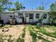 An overgrown backyard of a single Gathering house with assorted objects at 1266 Del Mar Pkwy, Aurora, CO 80010