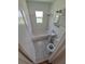 This cozy bathroom features a tiled floor and walls and includes a shower and tub combo at 1266 Del Mar Pkwy, Aurora, CO 80010