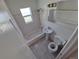 This bathroom boasts a shower and tub combination, tiled walls and floors, and bright natural light at 1266 Del Mar Pkwy, Aurora, CO 80010