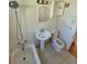 This bathroom includes a pedestal sink, toilet, tub and shower, and tiled walls and floors at 1266 Del Mar Pkwy, Aurora, CO 80010