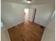 This bedroom has wood flooring and a window with natural light, and views to other rooms at 1266 Del Mar Pkwy, Aurora, CO 80010