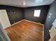 This bedroom has dark gray walls, wood flooring and a window at 1266 Del Mar Pkwy, Aurora, CO 80010