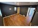 This bedroom has dark gray walls, wood flooring and a window, leading to the bathroom at 1266 Del Mar Pkwy, Aurora, CO 80010