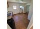 Well-lit kitchen with a gas range, refrigerator, and door to the outside at 1266 Del Mar Pkwy, Aurora, CO 80010