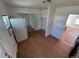 Bright kitchen leading to an adjoining room and featuring a refrigerator for convenience at 1266 Del Mar Pkwy, Aurora, CO 80010