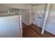 This kitchen has wood cabinets with a white refrigerator and vinyl wood flooring at 1266 Del Mar Pkwy, Aurora, CO 80010