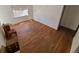 Bright living room featuring hardwood floors, natural light, and open access to other rooms at 1266 Del Mar Pkwy, Aurora, CO 80010