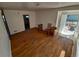 Bright living room featuring hardwood floors, natural light, and an open doorway to the backyard at 1266 Del Mar Pkwy, Aurora, CO 80010