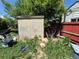 A shed in the overgrown yard of a single Gathering house at 1266 Del Mar Pkwy, Aurora, CO 80010