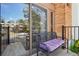 Cozy balcony with cushioned seating and sliding glass door access, offering a relaxing outdoor space at 6462 E Bates Ave, Denver, CO 80222