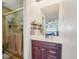 Cozy bathroom featuring a glass shower, dark wood vanity, and stylish decor at 6462 E Bates Ave, Denver, CO 80222