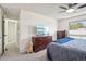 Bright bedroom with a ceiling fan, natural light, and an adjacent hall at 6462 E Bates Ave, Denver, CO 80222