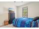 Bright bedroom with a bed, a window for natural light, and a dresser with a mounted TV at 6462 E Bates Ave, Denver, CO 80222