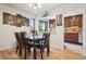 Elegant dining area with stylish lighting, hardwood floors and access to the kitchen at 6462 E Bates Ave, Denver, CO 80222