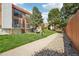 Exterior shot of the townhomes with balconies and grassy landscaping on a partly cloudy day at 6462 E Bates Ave, Denver, CO 80222
