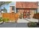 Charming townhome exterior with manicured landscaping, and a walkway to the front door at 6462 E Bates Ave, Denver, CO 80222