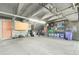 Parking garage featuring exposed pipes, overhead lighting and storage next to concrete floor at 6462 E Bates Ave, Denver, CO 80222