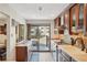 Bright kitchen featuring modern appliances, sleek countertops, and access to the patio at 6462 E Bates Ave, Denver, CO 80222
