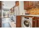Bright kitchen featuring stainless steel appliances, ample cabinet space, and a convenient in-unit washer at 6462 E Bates Ave, Denver, CO 80222