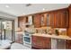 Well-appointed kitchen with stainless steel appliances, modern backsplash, and lots of storage at 6462 E Bates Ave, Denver, CO 80222
