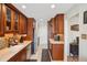 Well-lit kitchen with modern stainless steel appliances and wooden cabinetry, showcasing a clean and functional space at 6462 E Bates Ave, Denver, CO 80222
