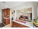 Charming kitchen featuring warm wood cabinetry and an open layout connecting to the dining and living area at 6462 E Bates Ave, Denver, CO 80222