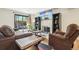 Comfortable living room with fireplace, sliding glass doors to fenced patio, and wood floors at 6462 E Bates Ave, Denver, CO 80222