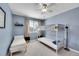 Cozy blue bedroom with a bunk bed, twin bed, and a ceiling fan for comfortable living at 5520 Morgan Way, Frederick, CO 80504