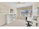 Bright bedroom with a ceiling fan, built-in shelving, desk, and a large window for natural light at 5520 Morgan Way, Frederick, CO 80504