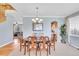 Elegant dining room with a wooden table, chandelier, and views into the kitchen, creating a warm atmosphere at 5520 Morgan Way, Frederick, CO 80504