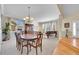 Inviting dining room featuring a wooden table, chandelier, and large windows, ideal for Gathering gatherings at 5520 Morgan Way, Frederick, CO 80504