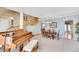 Open-concept dining room with a piano, wooden table, and access to the staircase, perfect for entertaining guests at 5520 Morgan Way, Frederick, CO 80504