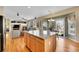 Open kitchen with stainless appliances, granite island, and sliding door at 5520 Morgan Way, Frederick, CO 80504