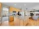 Open concept kitchen with large island, stainless appliances, and hardwood floors at 5520 Morgan Way, Frederick, CO 80504