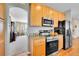 Kitchen boasts stainless steel appliances, granite countertops, and wood cabinets at 5520 Morgan Way, Frederick, CO 80504