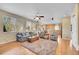 Bright and airy living room with a hardwood floor, ceiling fan, and an open layout, perfect for modern living at 5520 Morgan Way, Frederick, CO 80504