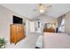 Bright main bedroom offering a tall dresser and a view into the bathroom at 5520 Morgan Way, Frederick, CO 80504