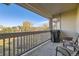 Spacious balcony with chairs and a grill, overlooking a backyard at 10437 W Hampden Ave # 202, Lakewood, CO 80227