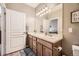 Double vanity bathroom with light wood cabinets and a large mirror at 10437 W Hampden Ave # 202, Lakewood, CO 80227