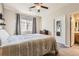 Bright bedroom with a queen bed and ensuite bathroom access at 10437 W Hampden Ave # 202, Lakewood, CO 80227