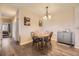 Bright dining area with a round table and chairs, adjacent to a hallway at 10437 W Hampden Ave # 202, Lakewood, CO 80227