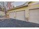 Three-car garage with light beige doors and stone accents at 10437 W Hampden Ave # 202, Lakewood, CO 80227