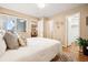 Bedroom with a view of the outside balcony and living room with a closet to the left with wood laminate flooring at 1825 Kendall St # 107, Lakewood, CO 80214