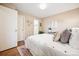 Cozy bedroom showcasing a neutral wall color, hardwood floors, and access to a closet and other rooms at 1825 Kendall St # 107, Lakewood, CO 80214