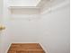 Empty white closet with laminate wood flooring at 1825 Kendall St # 107, Lakewood, CO 80214