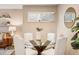 Bright dining area featuring a glass table and upholstered chairs, illuminated by natural light at 1825 Kendall St # 107, Lakewood, CO 80214