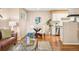 Charming dining area with a modern glass table and seating, adjacent to the kitchen at 1825 Kendall St # 107, Lakewood, CO 80214